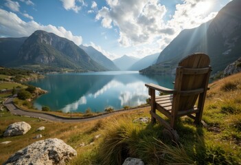 Serene lake view with mountains and a wooden chair overlooking the water