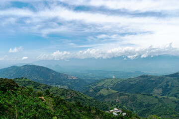 Obraz premium Breathtaking Panoramic View of the Green Mountainous Landscape of Colombia with Cloudy Sky