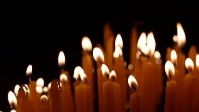Burnng candles shot in slow motion - candles followed by a camera dolly - pull back track