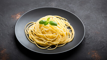 Dark plate with italian spaghetti on dark.