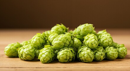 Obraz premium fresh green hops arranged artistically on a wooden surface, evoking a sense of natural beauty and freshness, typically used in brewing beer, set against a warm, neutral brown background