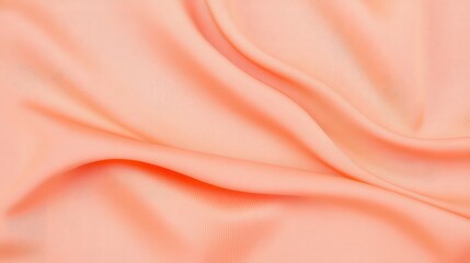 A smooth, flowing piece of peach-colored fabric, showcasing gentle folds and a soft texture that adds elegance and warmth.