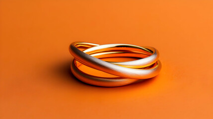 Fototapeta premium Three Gold Rings On Orange Background