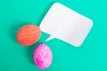 Bright Easter decoration with colored eggs and a blank speech bubble.