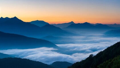 Fototapeta premium Mountains Looming Tall Over Misty Valleys in the Stillness of Early Day