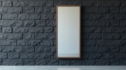 A modern, minimalist rectangular mirror hangs on a dark gray textured brick wall, reflecting a blank interior space.
