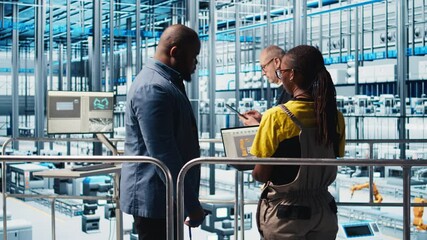 Engineers talking with manager overseeing smart photovoltaics factory, looking at system performance. Workers receive feedback from solar panels plant supervisor, tracking energy production, camera A