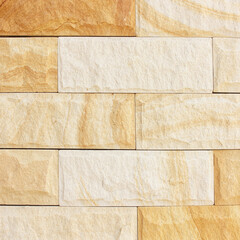 Antique brown paper texture set on a rough, ancient stone wall surface