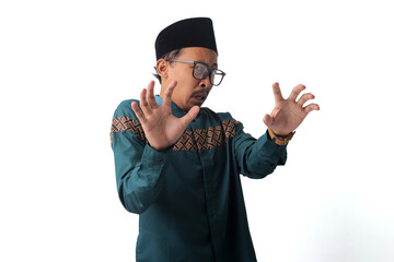 Asian Muslim man with a disgusted expression, repulsed by something, rejecting all kinds of...
