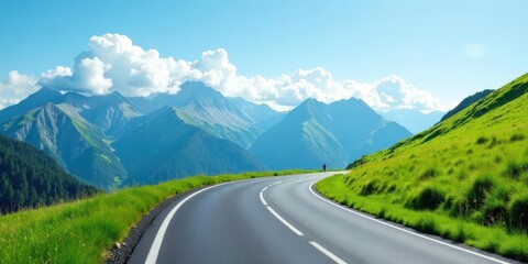 Fototapeta premium Asphalt Ribbon Unwinding Through Verdant Hills and Majestic Mountains Under a Summer Sky
