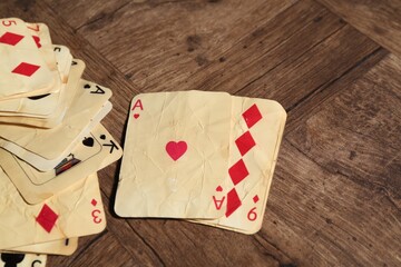 Old vintage playing cards on wooden table, closeup