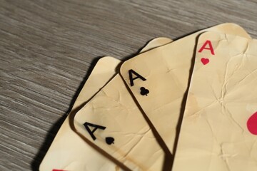 Many old vintage playing cards on wooden table, closeup