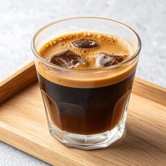 Refreshing Iced Coffee with Ice Cubes in a Glass on Wooden Tray