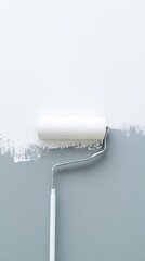 A paint roller is on a wall with paint on it. The roller is white and has a silver handle