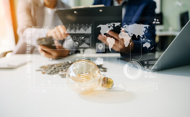 Showcasing innovation and finance. Business professionals with a glowing light bulb, coins, and digital tools symbolize