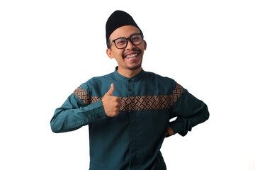 Confident and happy Asian Muslim man looking at the camera and showing a thumbs up, isolated on a...