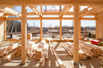 Rustic cottage under construction. Erection of wooden country estate. Construction site with boards...
