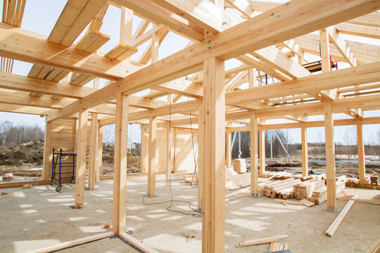 Frame building under construction. Erection residential buildings using half-timbered technology. Frame building made of boards and timber inside view. Half-timbered construction in countryside