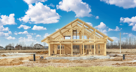 New country house at time construction. Country building frame made of wood. Development village...