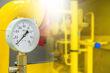 Gas equipment. Mechanical sensor on yellow pipes. Measuring pressure in gas pipeline. Compressor...