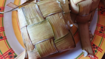Ketupat Rice Dumpling Special Dish served at Eid Mubarak. Ketupat is Cooked Rice with Young Coconut Leaves Casing Eid al Fitr Moslem Celebration 
