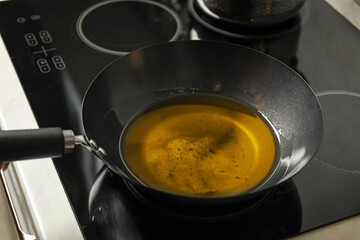 Used cooking oil in frying pan on stove in kitchen