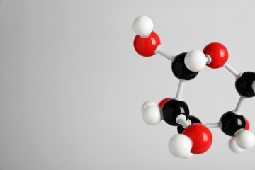 Molecule of glucose on light grey background, closeup and space for text. Chemical model