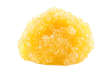 Close up of a single piece of crystallized ginger on a black background in studio lighting