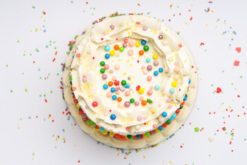 Delicious bento cake with colorful sprinkles on light table, top view