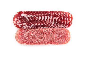 Slices of different tasty smoked sausages on white background, top view