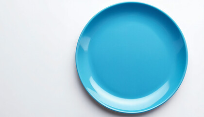 a blue plate on a white table, with copy space