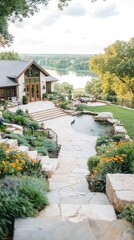 Naklejka premium Hillside home with stone patio, landscaping, and river view