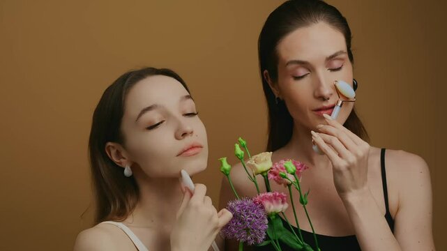 Beauty enthusiasts share skincare tips with floral accents in studio setting