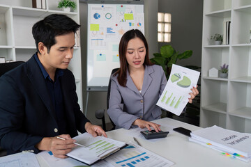 Team Collaboration and Financial Review. Colleagues analyzing financial data while showcasing a report.