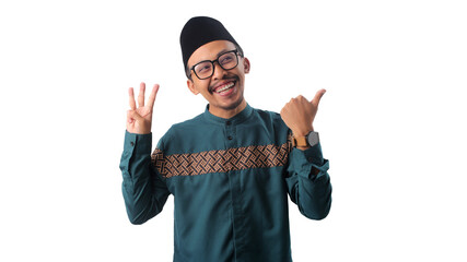 Excited Asian Muslim man raising four fingers with a big smile, making a number four or fourth-place gesture while looking at the camera, isolated on a white background