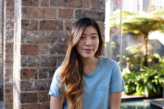 Young Asian woman enjoying time outdoors at enclave