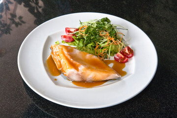 Black cod fillet with miso and green salad with tomatoes, Japanese food