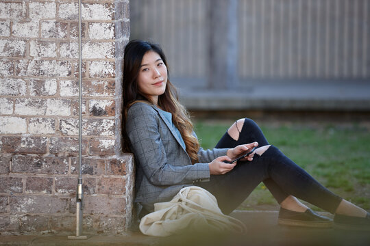 Young Asian woman enjoying time outdoors at enclave