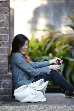 Young Asian woman enjoying time outdoors at enclave