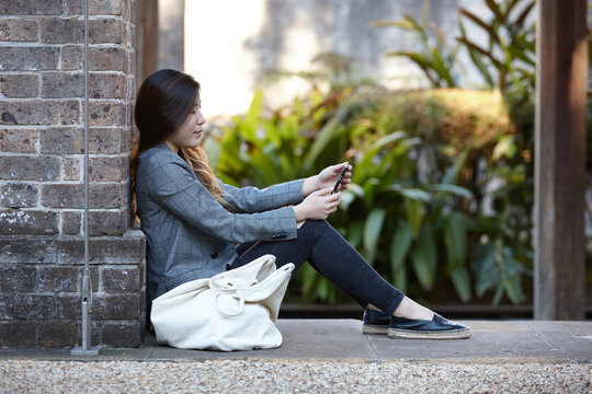 Young Asian woman enjoying time outdoors at enclave