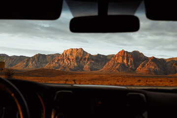 car in the desert overlooking the mountains