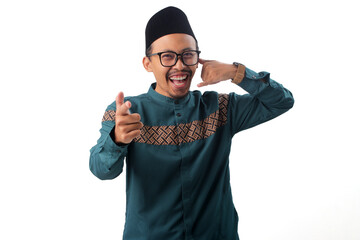 Fototapeta premium Smiling Asian Muslim man standing while making a 