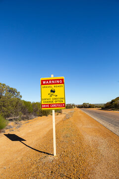 outback road sign warning of changing road conditions