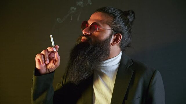 Refined scholar draws thoughtfully on his cigarillo