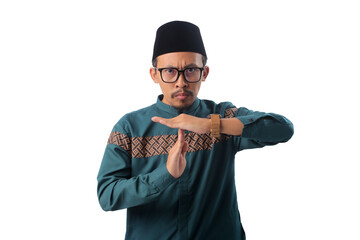 Asian Muslim man making a timeout gesture, signaling that suhoor (pre-dawn meal) time has ended and...