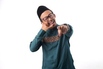 Cheerful Asian Muslim man smiling and blinking while making a 