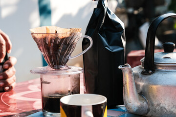 People morning talk with drip brewing coffee by paper filtered on table