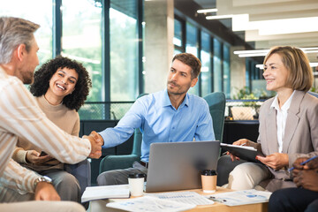 Diversity, professional and employee business people shaking hands in the office for a deal,...