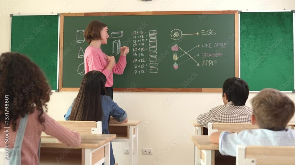 Poster front view of caucasian teacher teaching student in math lesson in elementary school while diverse c