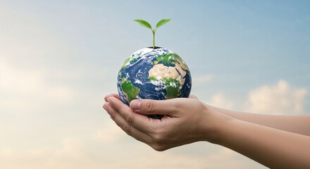 Hands holding a mini planet with green sprout against blue sky
